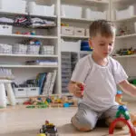 A little boy playing in a kids' playrooms.