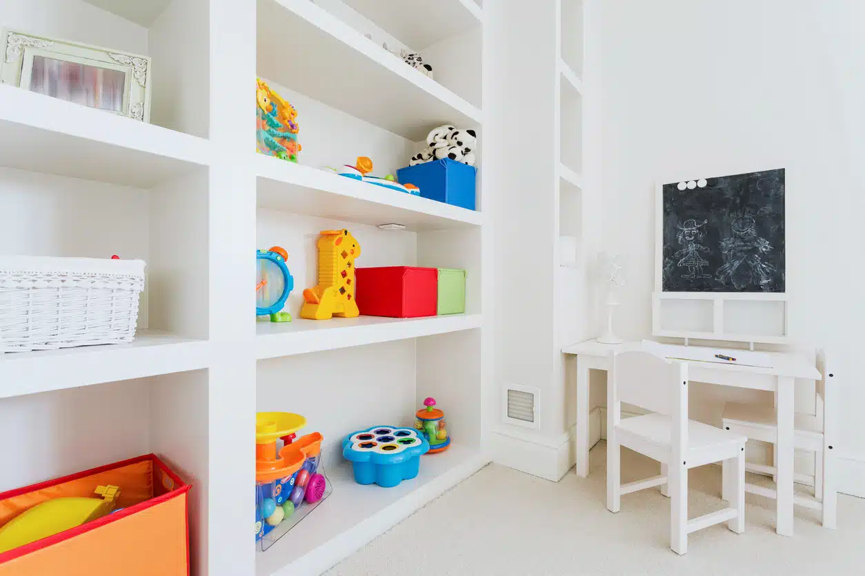 Zoom of white wooden furniture in child room
