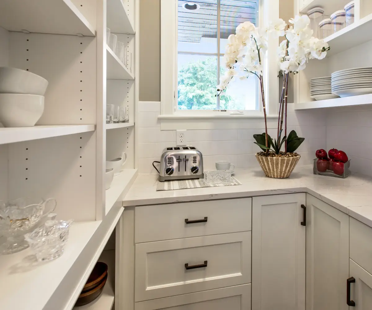 Kitchen Pantry Cabinets - a white cabinets and shelves with white plates and bowls