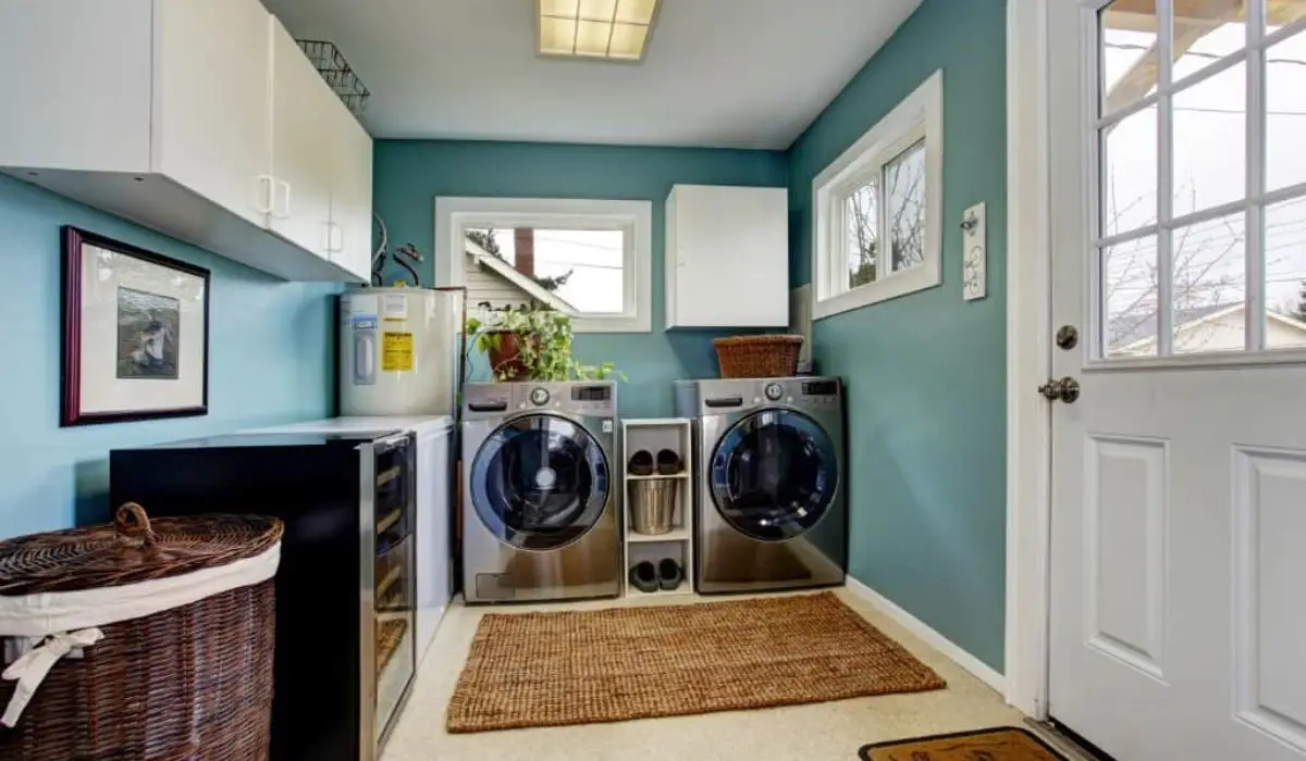A teal and white small laundry rooms