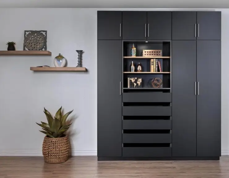 Dark wall cabinetry that is on a grey wall